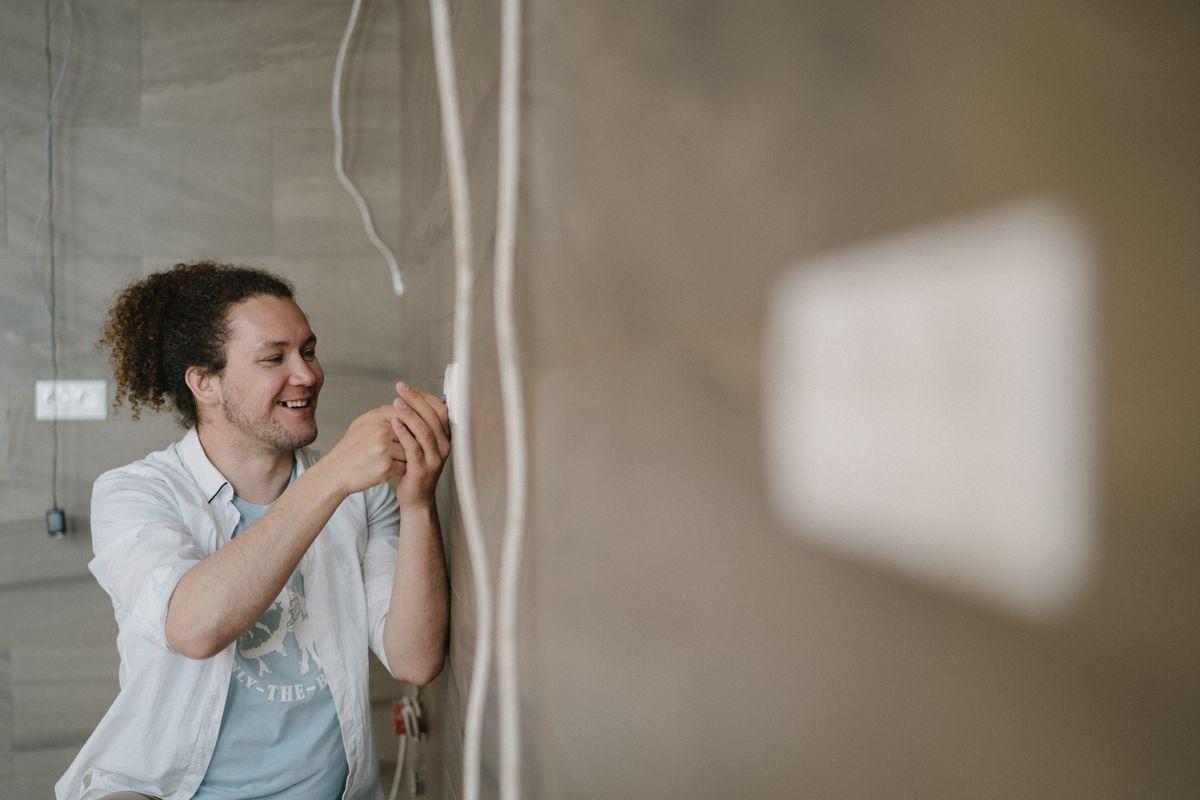 An electrician installing an outlet